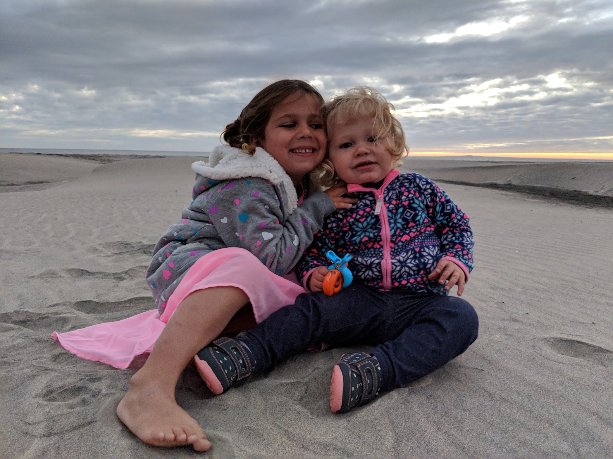 sisters on a sand dune